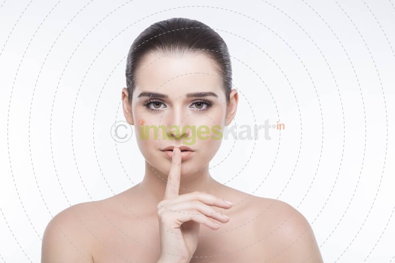 girl posing with finger on her lips