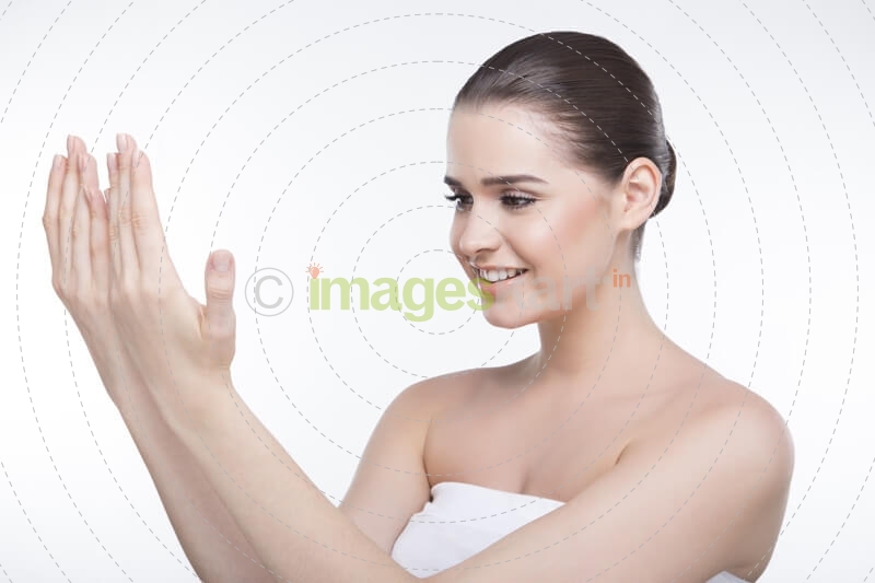 girl with beautiful skin looking at her hands