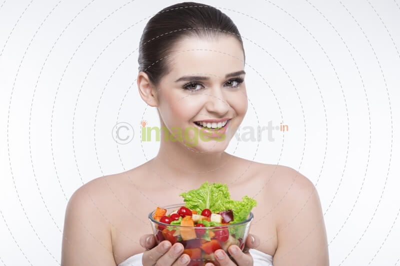 girl smiling and posing with salad