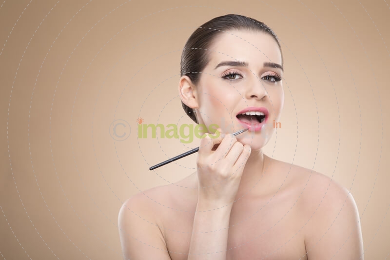 girl applying make up with brush