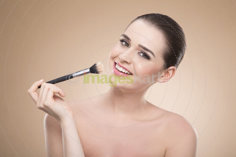 girl applying make up with brush