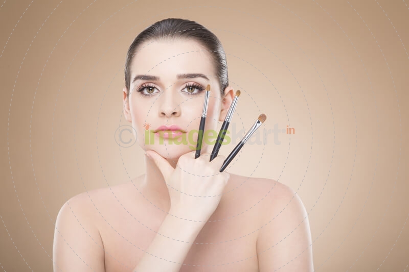 girl posing with make up brush