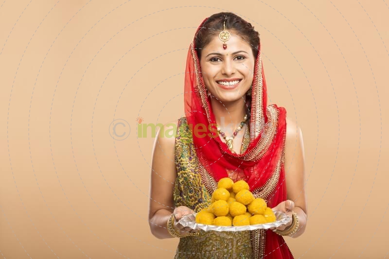 woman posing with laddu
