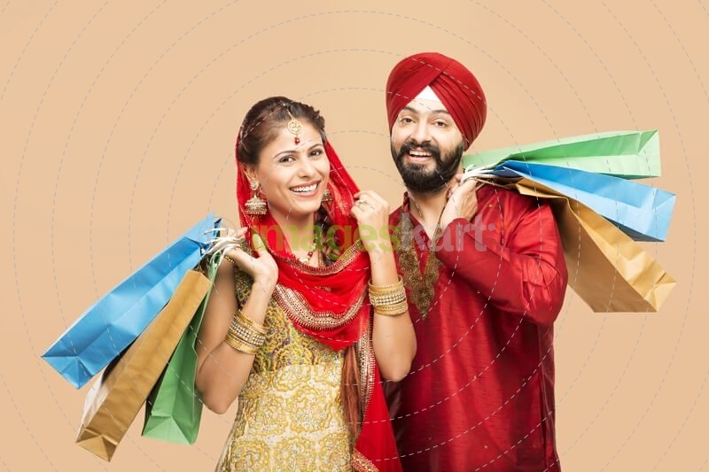 sikh couple posing with gifts and sweets