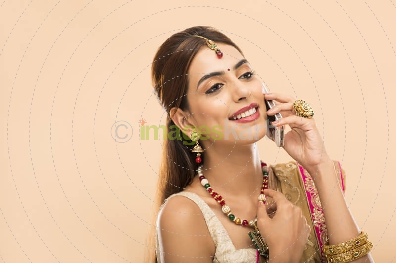 woman in traditional wear talking on phone 