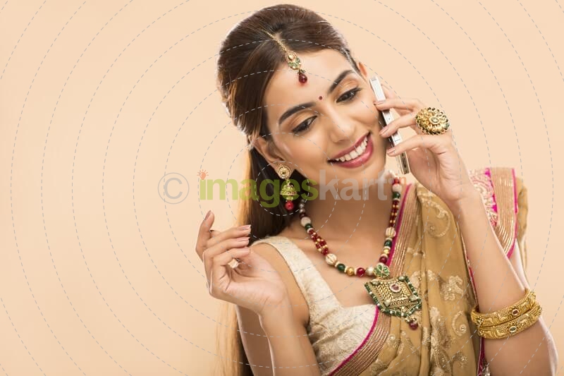 woman in traditional wear talking on phone 