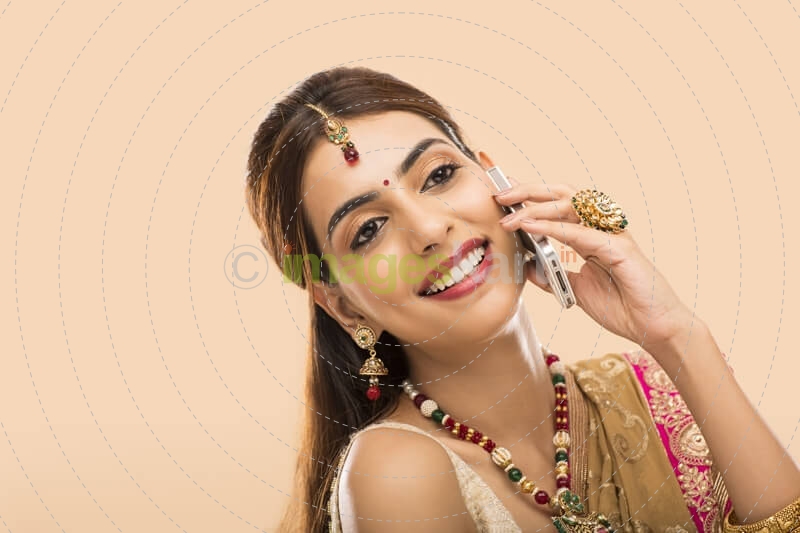 woman in traditional wear talking on phone 