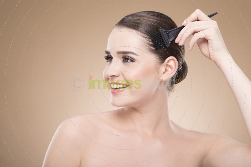 beautiful girl applying hair color