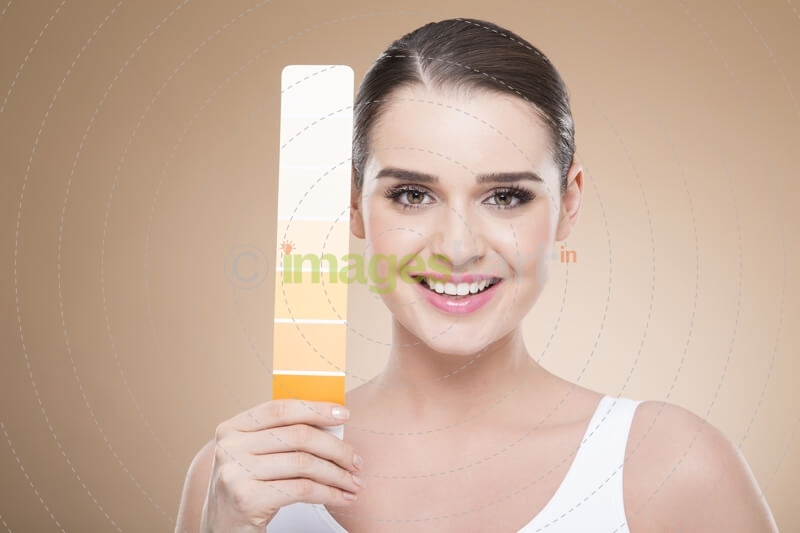 woman with skin shade card