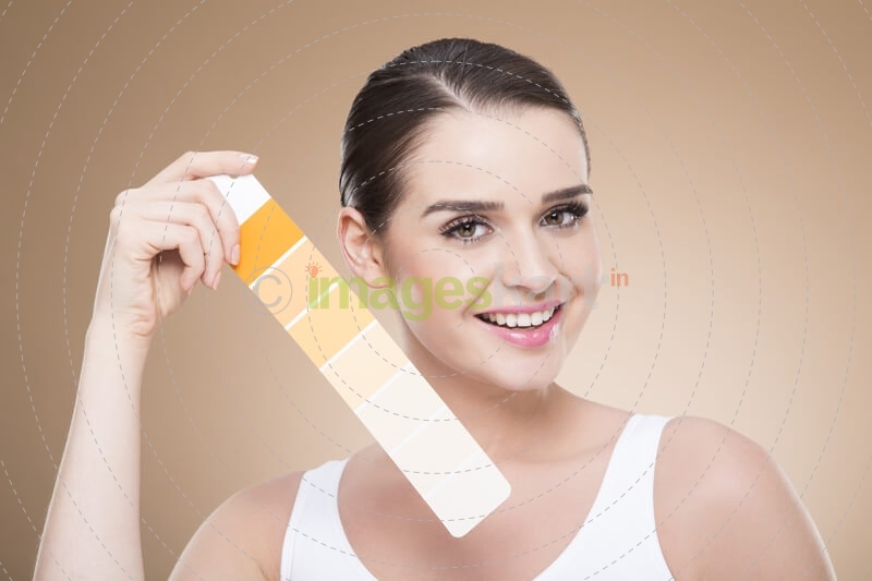 woman with skin shade card