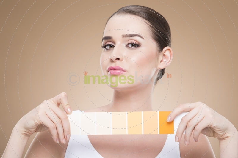 woman with skin shade card