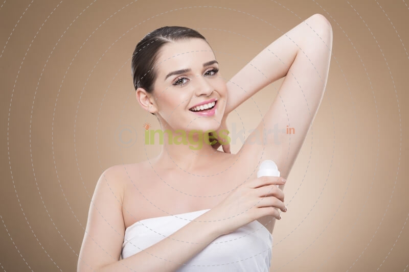 woman applying deodorant stick