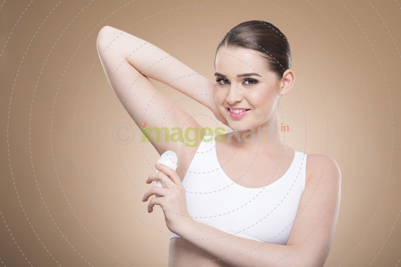 woman applying deodorant stick