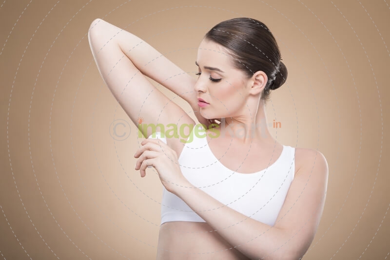woman applying deodorant stick