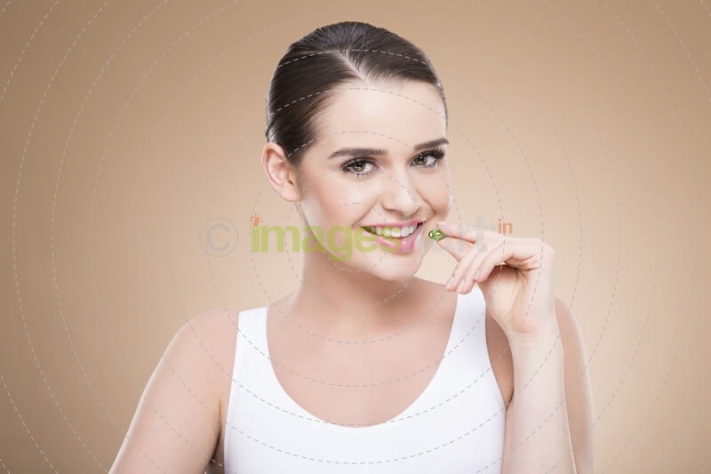 beautiful girl posing with green pill
