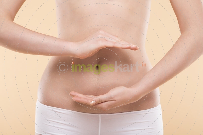 girl make healthcare gesture on her stomach 