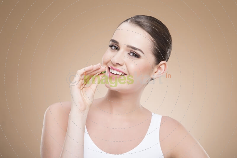 beautiful girl posing with green pill