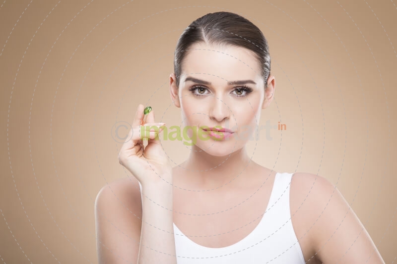 beautiful girl posing with green pill