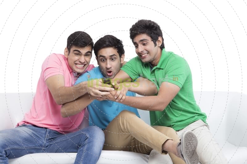 friends fighting for television remote