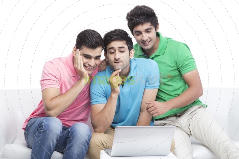friends having fun time while browsing on laptop