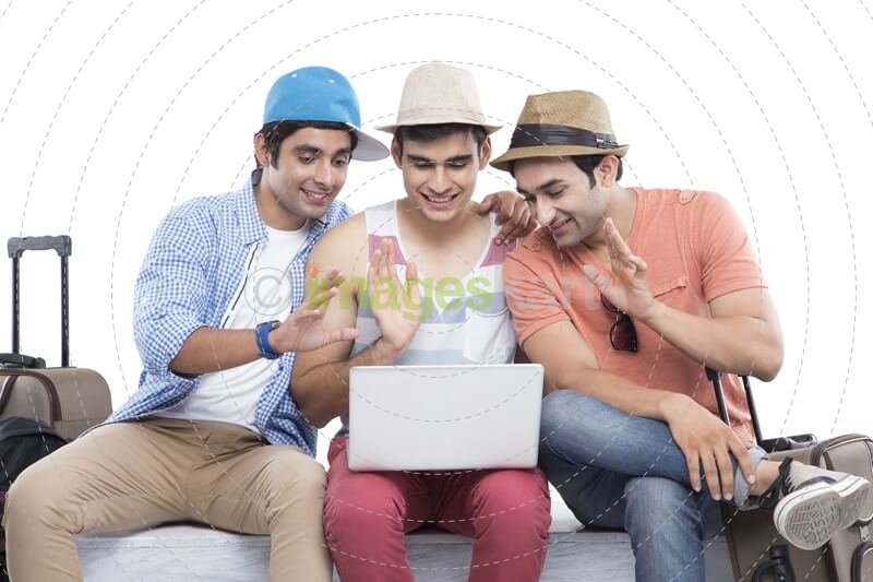friends on vacation checking with laptop