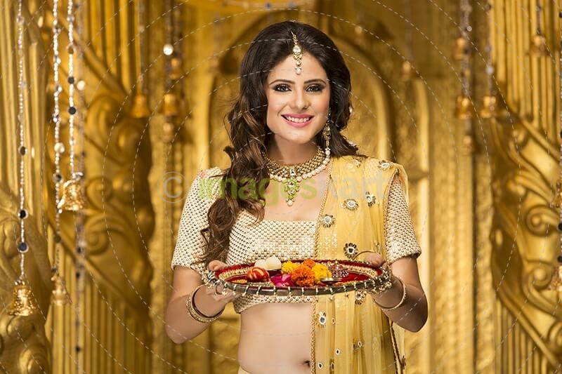 woman in traditional wear with pooja thali