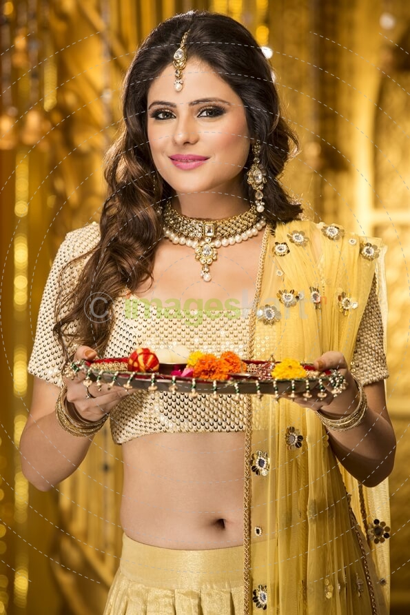 woman in traditional wear with pooja thali