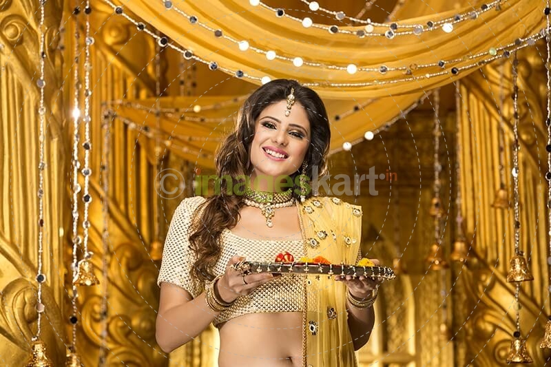 woman in traditional wear with pooja thali