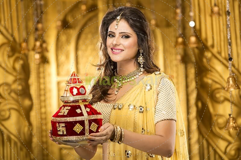 woman in traditional wear with kalash 
