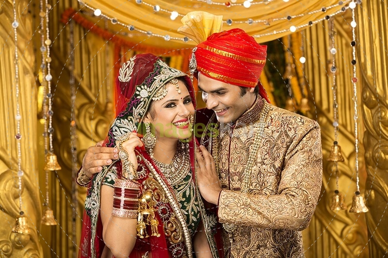 indian bride and groom posing 