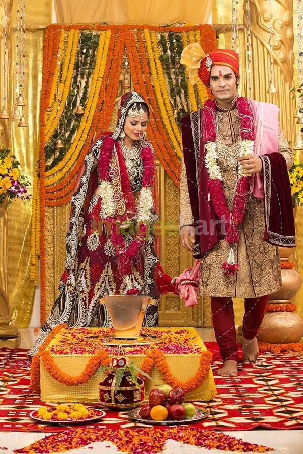 indian bride and groom taking pheras