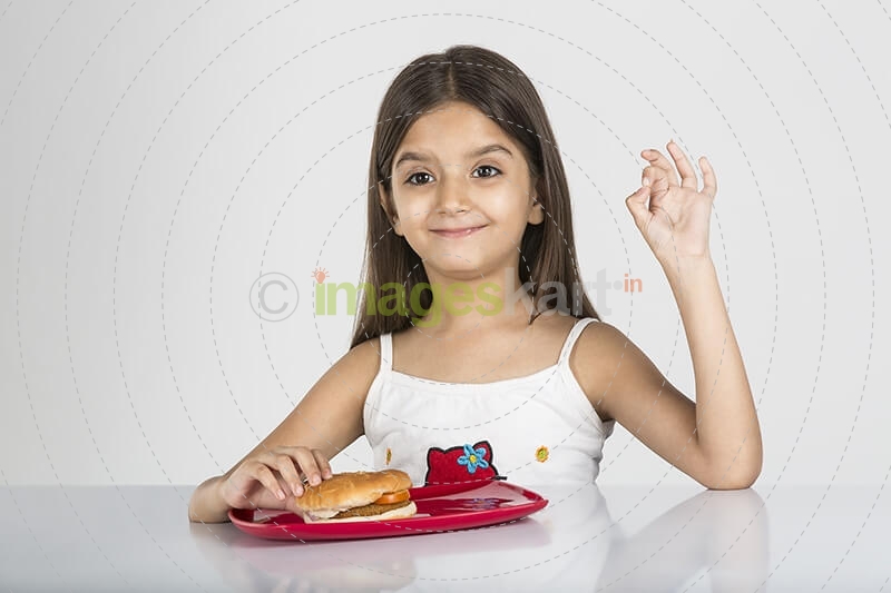 cute little girl posing with delicious burger