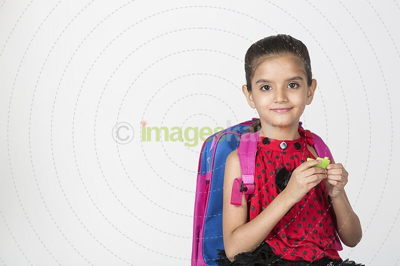 cute girl carrying bag smiling and posing