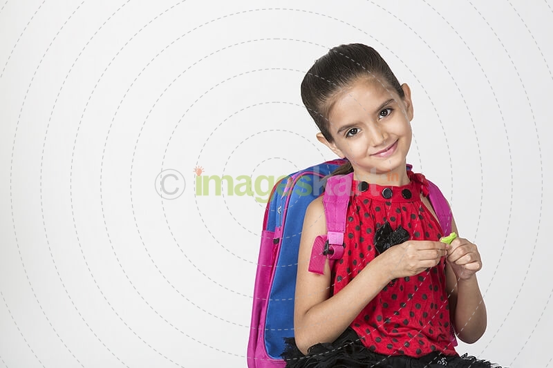 cute girl carrying bag smiling and posing
