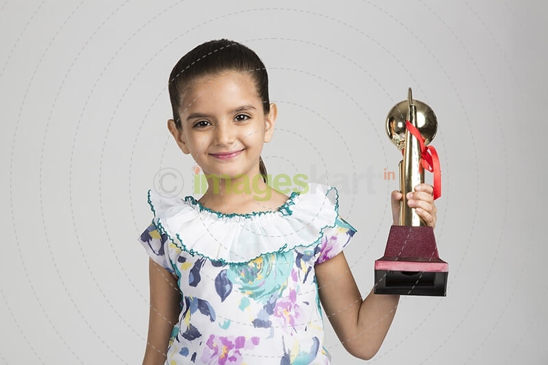 cute kid holding trophy