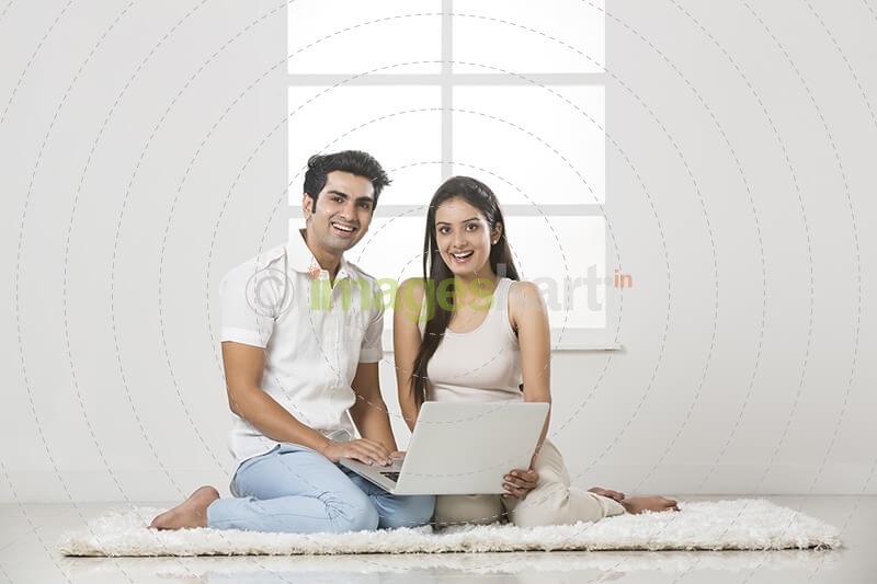 couple at home working on laptop