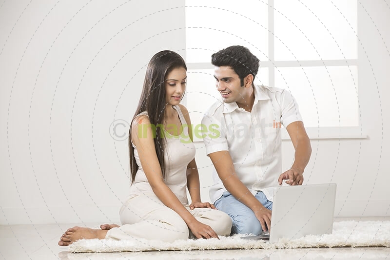 couple at home working on laptop