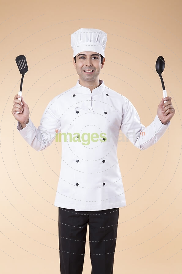 chef posing with spatula and ladle