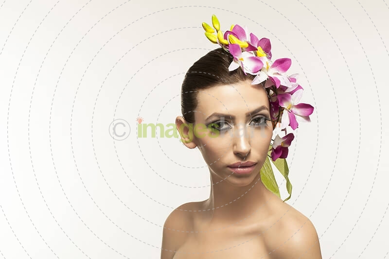 beautiful young woman posing with flowers in hair