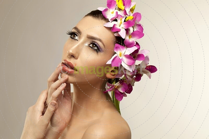 beautiful young woman posing with flowers in hair