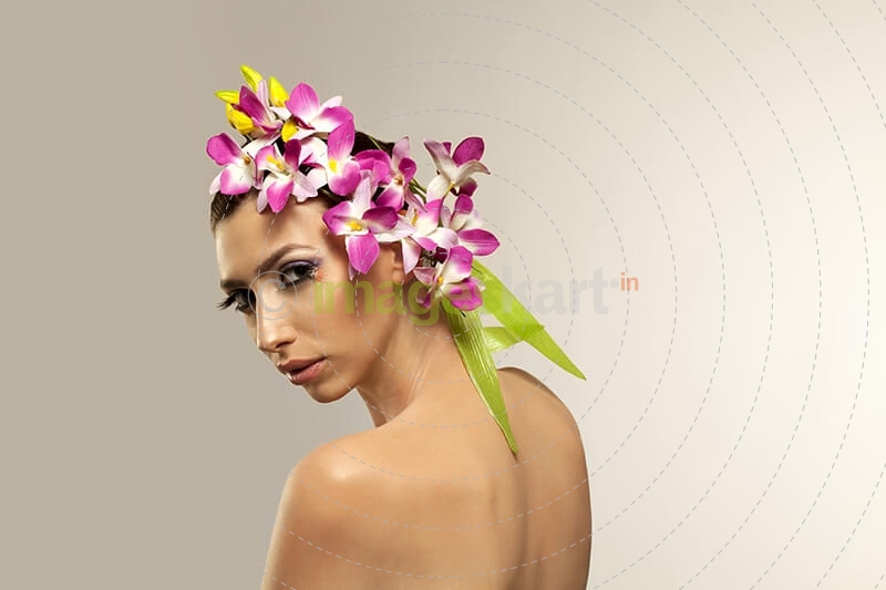 beautiful young woman posing with flowers in hair