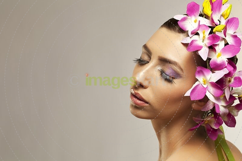 beautiful young woman posing with flowers in hair