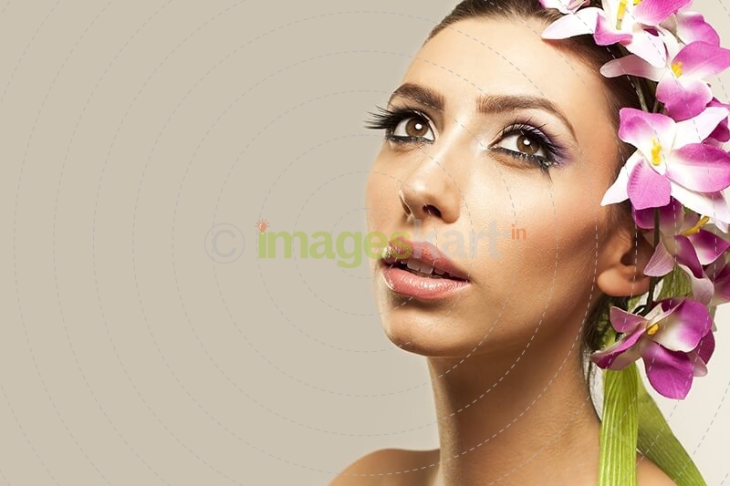 beautiful young woman posing with flowers in hair