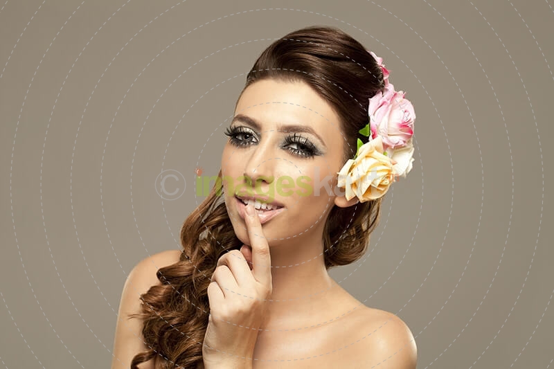 beautiful woman posing with roses in hair