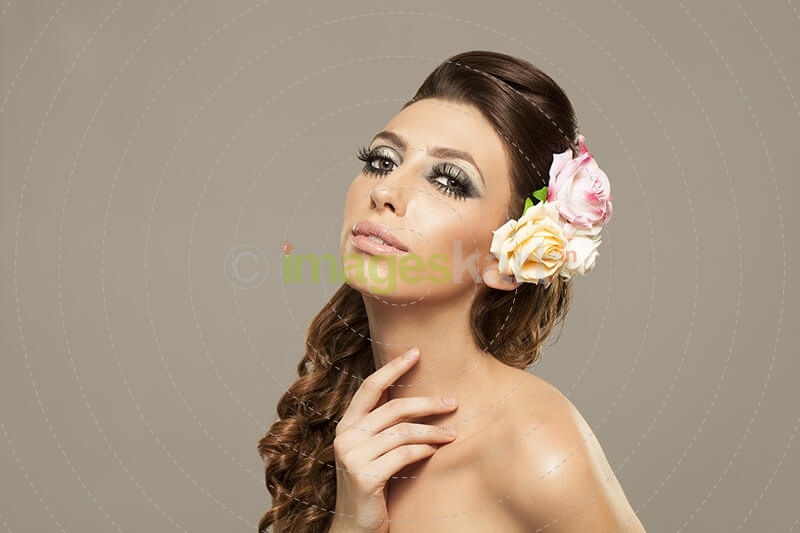 beautiful woman posing with roses in hair