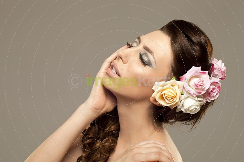 beautiful woman posing with roses in hair