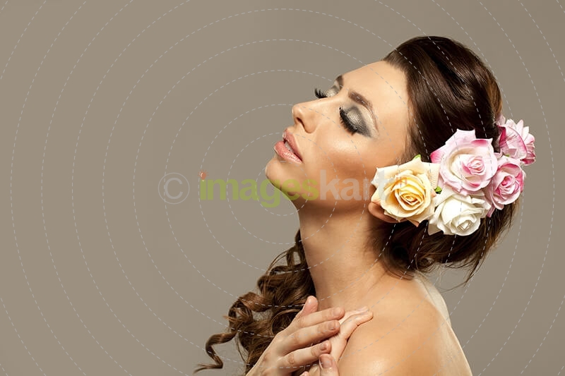 beautiful woman posing with roses in hair