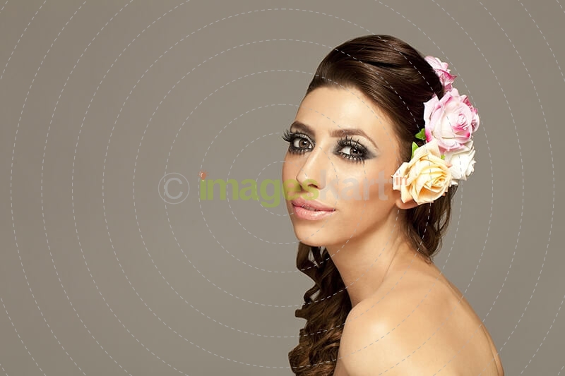 beautiful woman posing with roses in hair