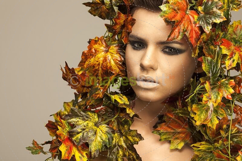 woman covered in leaves 