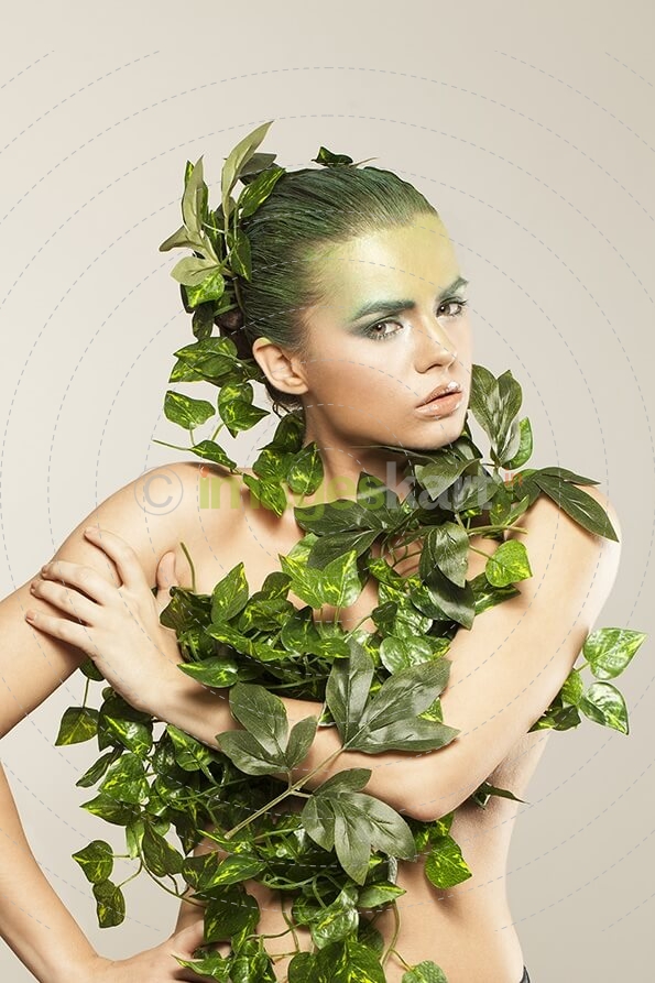 woman covered with green leaves